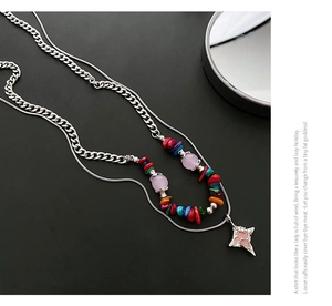 Close-up of double-layer necklace with colorful beads and a pink star pendant