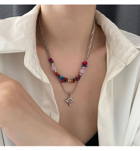 Macro view of a colorful double-layered beaded necklace with a silver star pendant