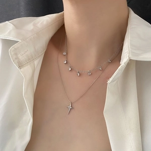 Collier double rang argenté avec pendentif étoile et zircons porté par un mannequin