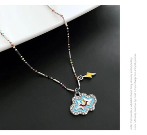 Detail of blue cloud smile pendant with lightning charm and colorful beaded chain necklace