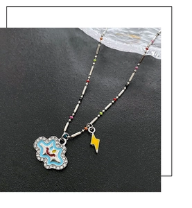 Close-up of cloud pendant with colorful beads and yellow lightning bolt charm