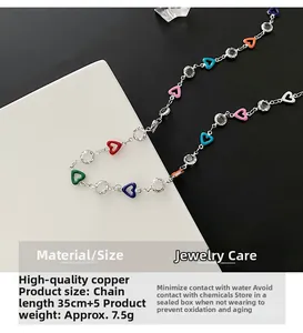 Detail view of colorful enamel heart necklace with copper chain and crystal beads