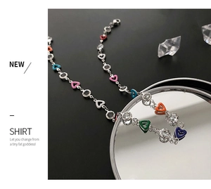 Detailed close-up of colorful heart charms and crystals on a silver chain necklace