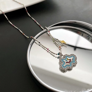 Smiling cloud pendant necklace with blue enamel, crystals, and yellow lightning charm