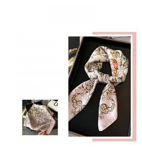 Detail view of floral silk scarf with baroque pattern and elegant pink golden motifs