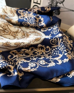 Close-up of luxury satin floral scarf with gold Baroque patterns and silk texture