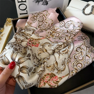 Detailed view of luxury floral silk scarf with baroque patterns in elegant gift box