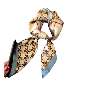 Elegant silk-like square scarf featuring classic golden chain print and geometric patterns