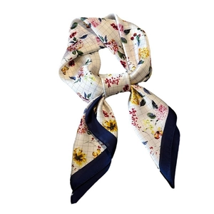 Floral ivory silk scarf with grey check pattern and navy contrast border tied in a bow