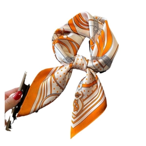 Classic orange silk scarf with chain and shield print tied in a decorative bow style