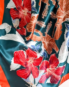 Close-up of tropical floral print satin scarf showing smooth texture and drapes