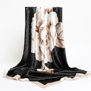 Detailed view of satin square scarf featuring elegant camellia print and silky texture
