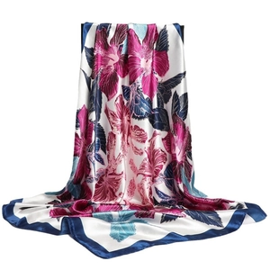 Elegant white satin square scarf with colorful floral patterns and deep blue borders