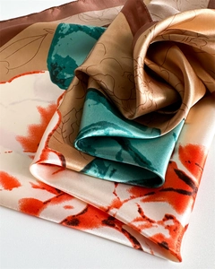Close-up of satin silk scarf with abstract floral patterns and smooth glossy texture