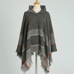 Détail de la texture à chevrons sur poncho à capuche gris avec rayures orange