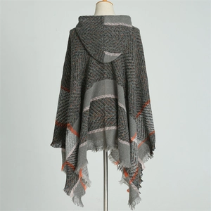 Détail d'un poncho à capuche gris foncé avec tissage à chevrons et rayures orange