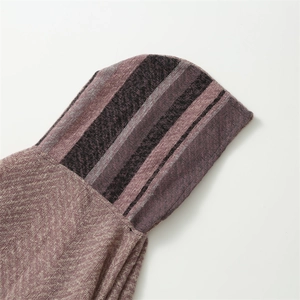 Detail of the thick purple and grey striped knit fabric on the hooded poncho scarf