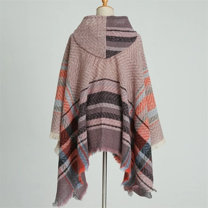 Detailed texture of hooded plaid poncho featuring soft tassels and herringbone pattern