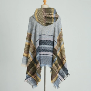 Detail of the hooded checkered poncho cape showing multi-color plaid pattern and fringe trim