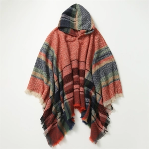 Detailed close-up of hooded poncho scarf showing heavy knit plaid pattern and fringed edges