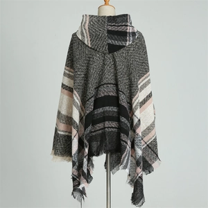 Detail of hooded plaid poncho with fringe trim and soft knit herringbone texture