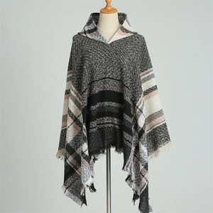 Detail of hooded plaid poncho featuring grey pink check pattern and soft tassel edges