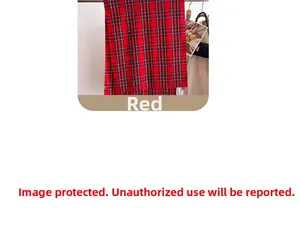 Detail of red and grey plaid tassel scarf draped on a metal rod for winter fashion