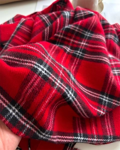 Close-up of red and black plaid cashmere-like scarf fabric with soft texture detail