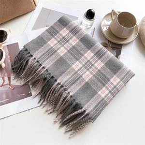 Plaid cashmere-like scarf in grey, pink, and beige with fringe trim on white background
