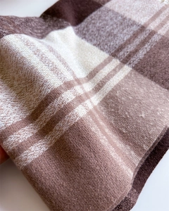 Close-up of rainbow plaid cashmere-like fabric showing soft texture and thick weave pattern
