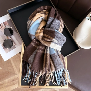 Classic rainbow plaid cashmere scarf with fringes arranged in a luxury fashion setting