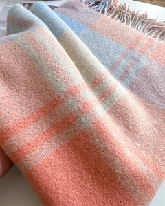Close-up of soft rainbow plaid cashmere-like fabric with delicate fringe details
