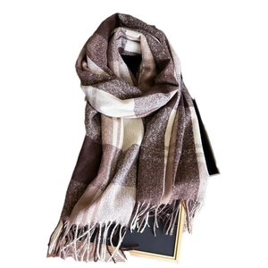 Winter plaid scarf with vintage brown checkers and long fringe on a wooden display