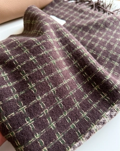 Détail d'une écharpe épaisse à carreaux en cachemire avec motif vintage vert et blanc