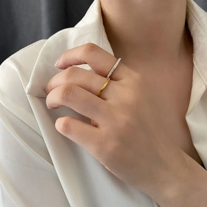 Minimalist titanium steel ring set with zircon accents shown on a model's hand