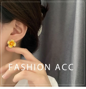 Detail of sweet orange flower stud earring with gold plating and glossy enamel finish