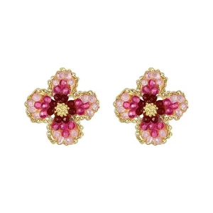 Pink floral beaded earrings with gold trim on a white background for women