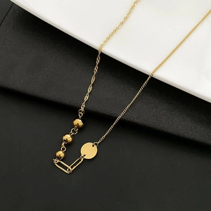 Asymmetric gold titanium necklace featuring metal beads and minimalist mixed chain link design