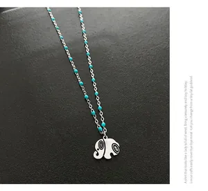 Detail of silver elephant pendant on minimalist beaded chain necklace for women