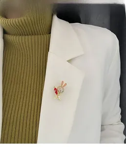 Cute bunny brooch with zircons and pearl pinned to a white blazer lapel