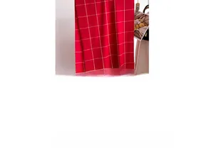 Detail of red checkered cashmere-like scarf fabric showing soft fringe and plaid pattern