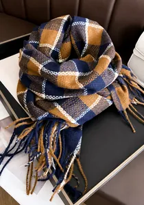 Detail of classic plaid cashmere scarf with fringes and elegant navy brown pattern