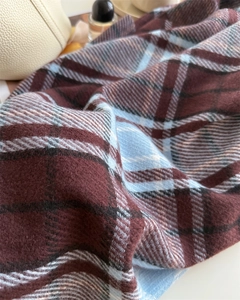 Close-up of soft burgundy and blue plaid faux cashmere scarf with brushed texture
