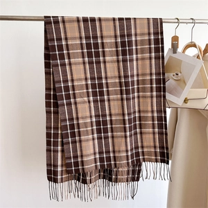 Close-up of brown plaid scarf fringe detail and soft faux cashmere fabric texture