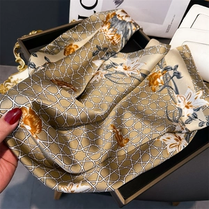 Detail of silk-texture square scarf with floral pattern and soft champagne sheen