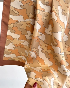 Close-up of silk twill scarf showing beige camouflage print and fine texture detail