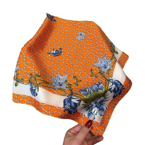 Floral orange square silk scarf with blue flower patterns and geometric grid border