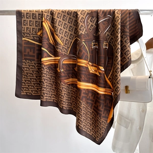 Detailed view of silk square scarf with chain patterns and luxury letter monogram print