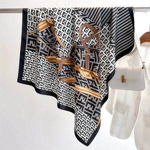 Close-up of retro twill silk scarf with letter patterns and chain print texture