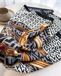 Macro view of French retro silk scarf with elegant chain print and satin texture finish
